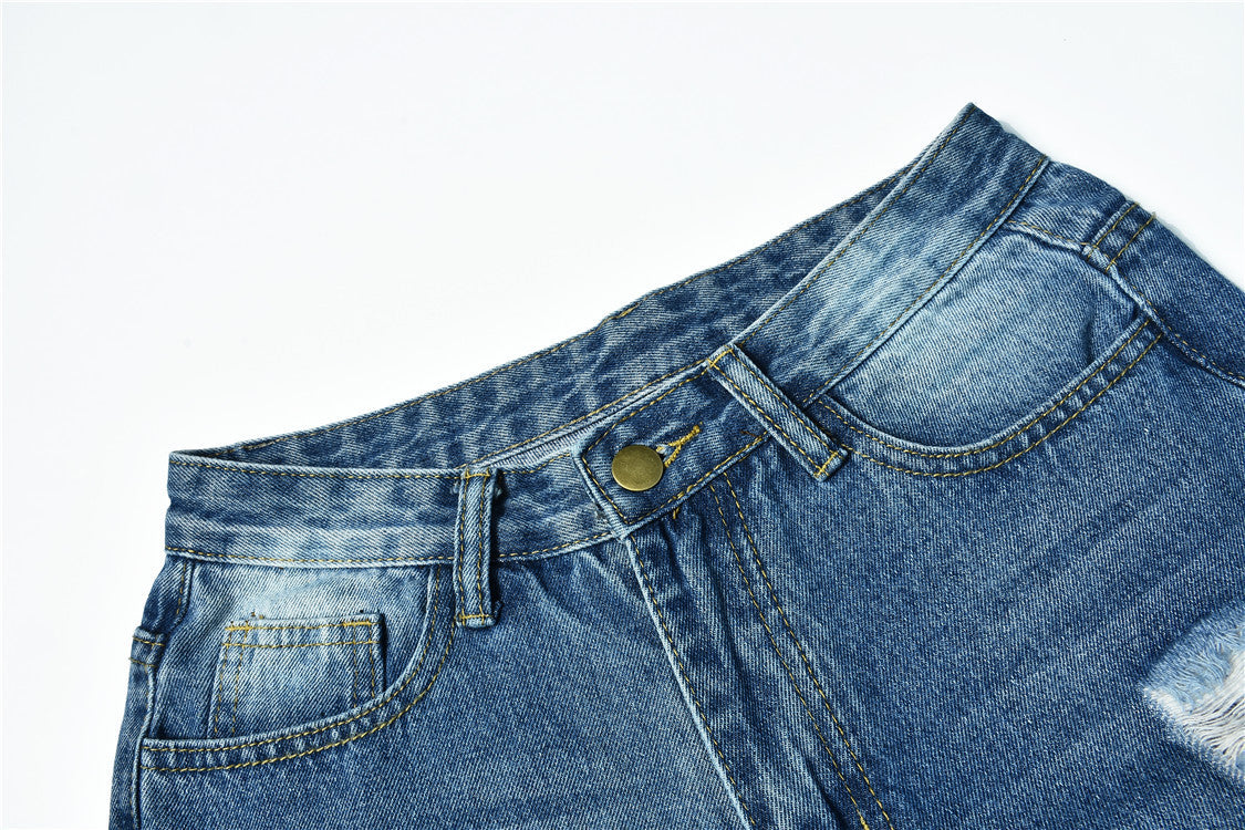 Blue mid-waist ripped women's denim jeans with distressed and faded details