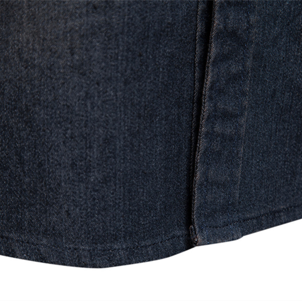 Close-up of dark blue men's long-sleeved denim shirt fabric and seam detail