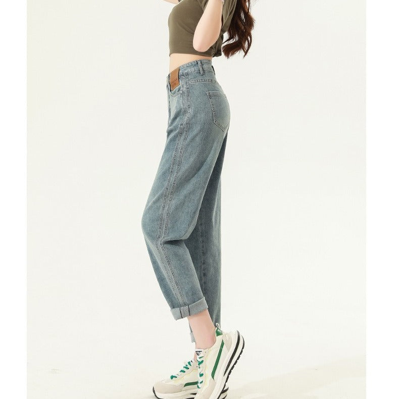 Woman wearing retro blue high waist straight harem jeans with cropped length and rolled cuffs