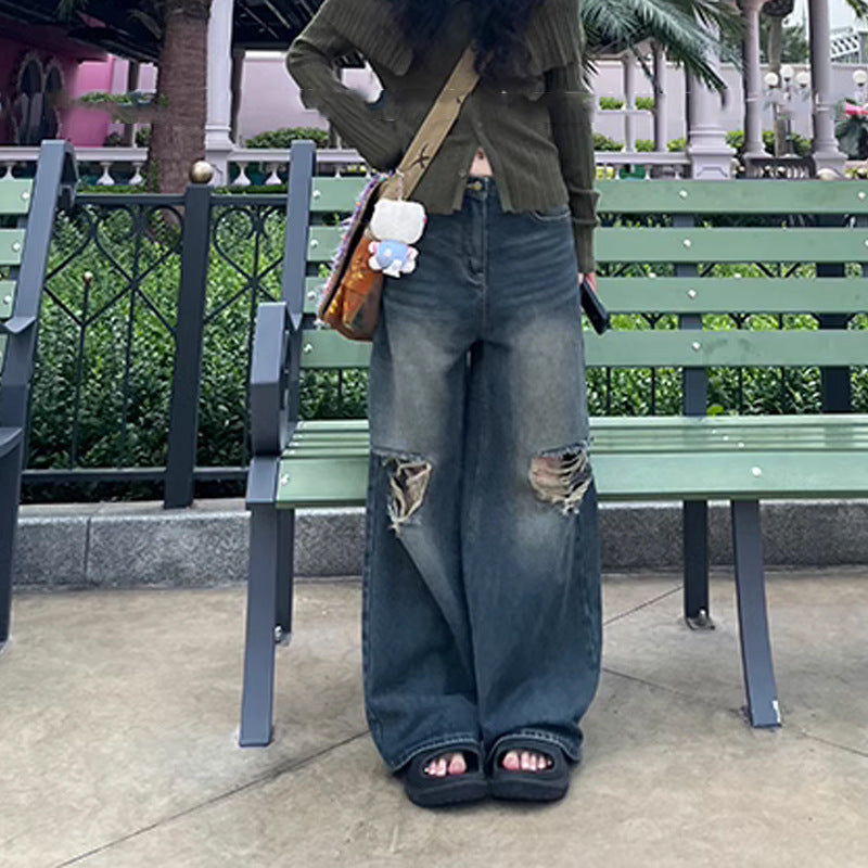 Women wearing blue retro washed ripped straight-leg jeans with micro elasticity and open-toe black sandals outdoors