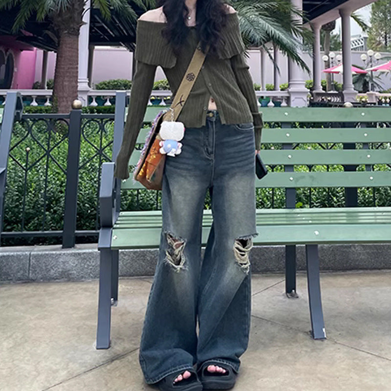Woman wearing retro washed ripped jeans with straight-leg fit and micro elasticity in blue cotton fabric outdoors by a bench