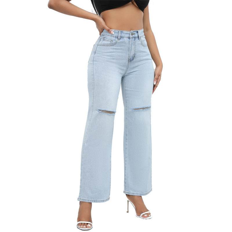 Woman wearing light blue elegant ripped wide-leg jeans with mid waist and straight-leg cut