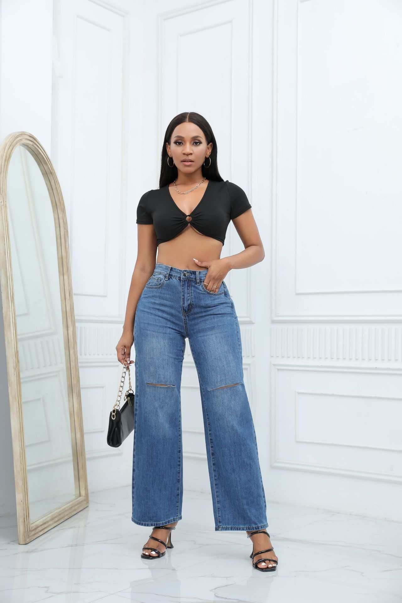 Elegant ripped wide-leg denim jeans for women in medium blue with mid waist and straight-leg design